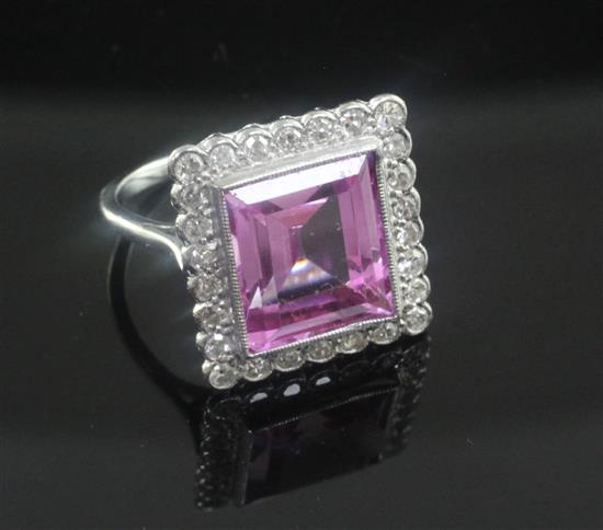 A 18ct white gold, synthetic pink sapphire and diamond cluster dress ring, size K.